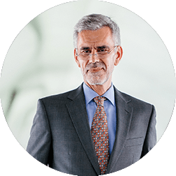 ph-testimonial-24 Older man with grey hair in a business suit