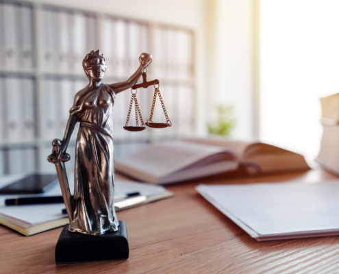 Lady Justice statue in law firm attorney office, blindfolded Justitia with balance scales and sword is personification of moral force in judicial system