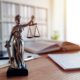 Lady Justice statue in law firm attorney office, blindfolded Justitia with balance scales and sword is personification of moral force in judicial system