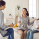 Female therapist listening to parent asking for advice and guidance. Single mother sitting on couch with sad unhappy preteen child and discussing social behaviour problems with counseling psychologist