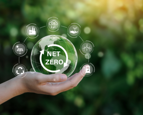 Net zero icon and carbon neutral concept in the hand for net zero greenhouse gas emissions target Climate neutral long term strategy on a green background.