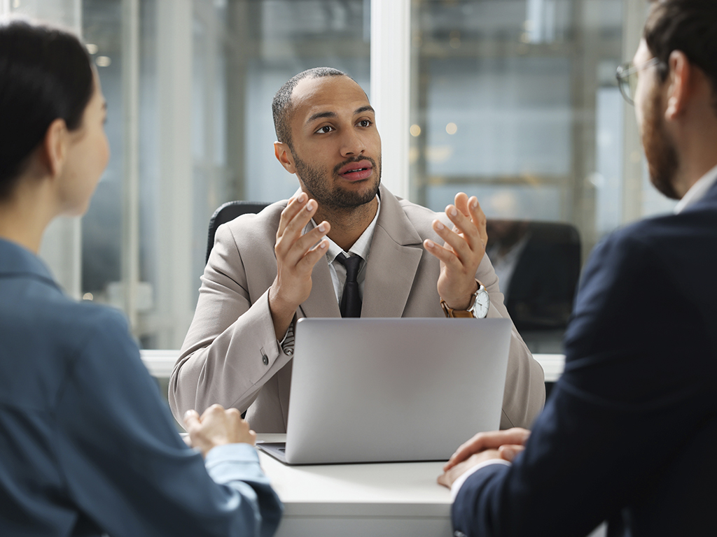 AdobeStock_748600226-edit A solicitor talking to two people in an office