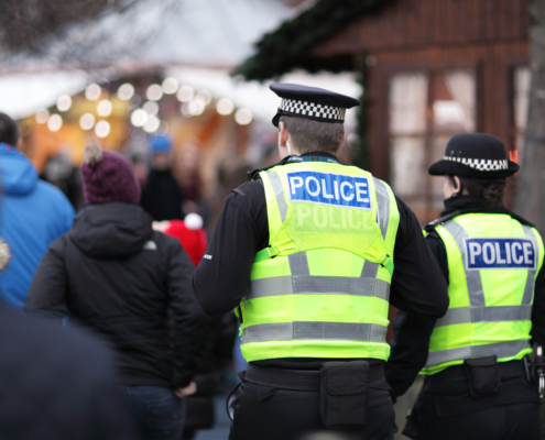 Police in hi-visibility jackets policing crowd control at a UK event