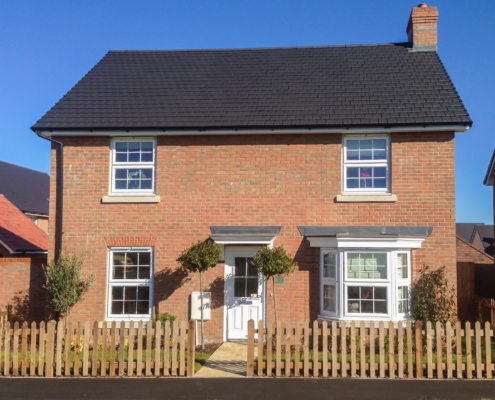 A new house and wooden picket fence.