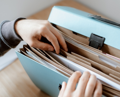 Someone looking through a paper folder