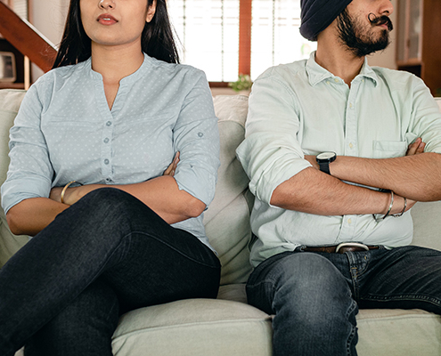 A man and a woman sitting next each other on a couch
