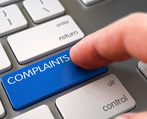 Hand Pushing Blue Complaints Modern Laptop Keyboard Key. 3D Illustration.