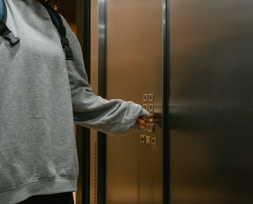 Someone pressing an elevator floor number