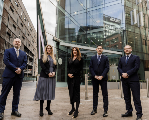 5 People standing outside a building