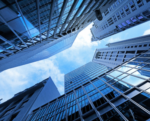 A view looking up at several skyscrapers