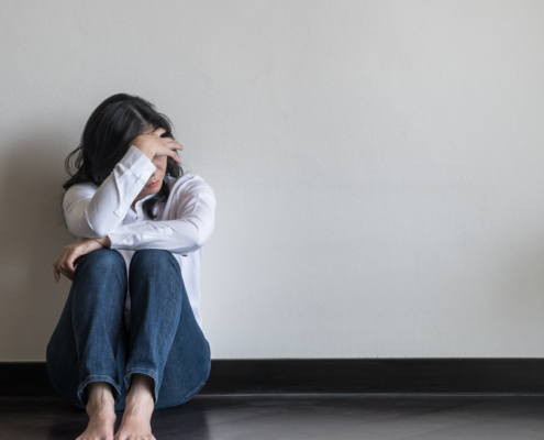 A woman sat on the floor in distress