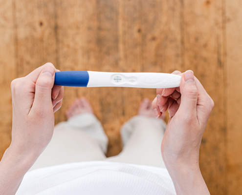 A woman holding a pregnancy test
