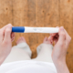 A woman holding a pregnancy test