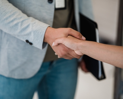 Two women shaking hands
