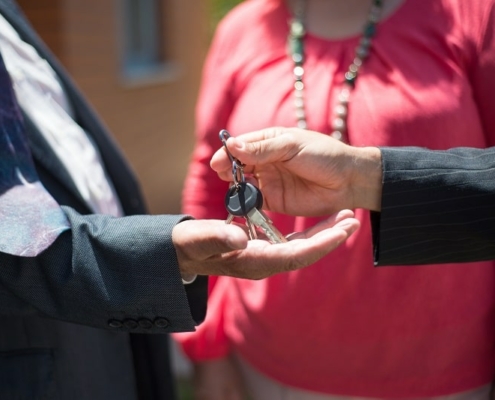 Someone handing keys to someone else