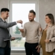 A property landlord giving keys to a man and a woman