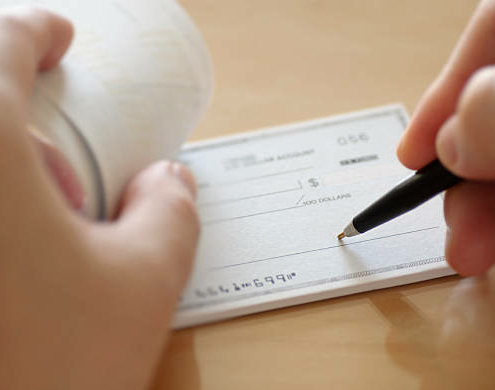 Businessman prepare writing check in the office