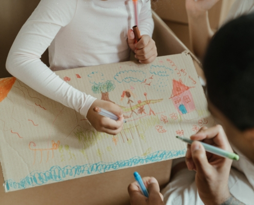 Two children drawing on paper