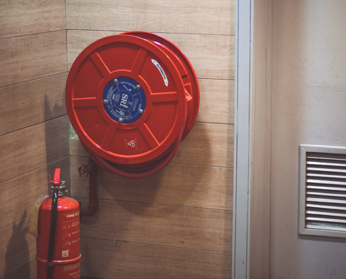 A water hose and fire extinguisher
