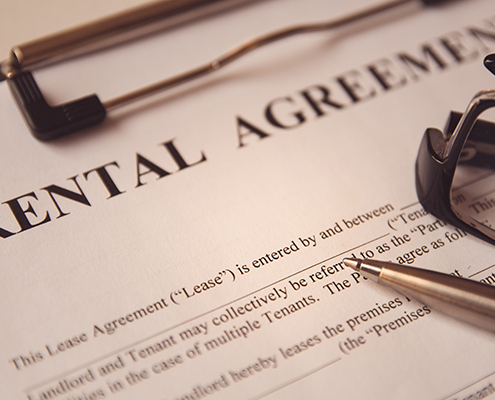 Business legal document concept : Pen and glasses on a rental agreement form.