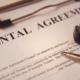 Business legal document concept : Pen and glasses on a rental agreement form.