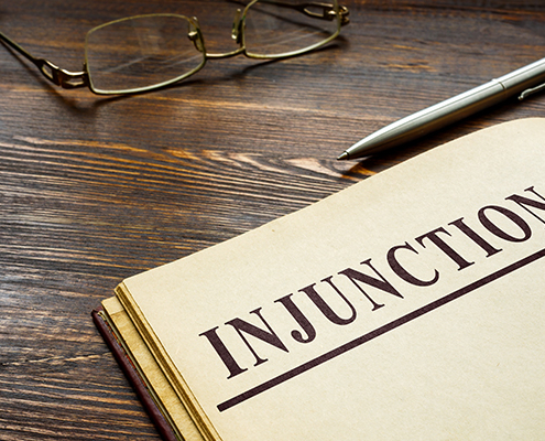 Injunction word on the top of page and pen.