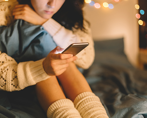 A Girl texting on smartphone at home