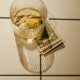 A spirit glass with cash under it