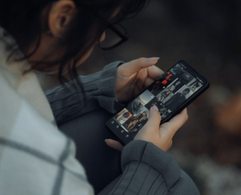 Someone looking and scrolling through their mobile phone