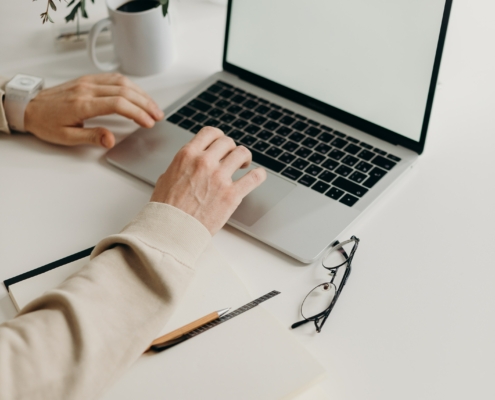 Someone typing on a laptop
