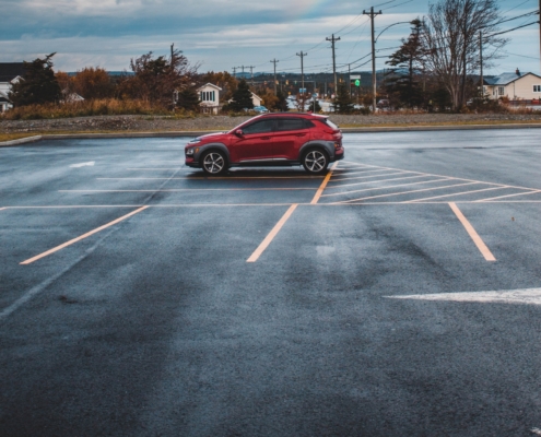 An abandoned car in a car park