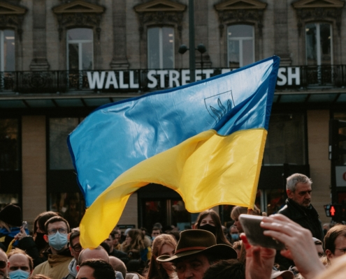 Someone holding a Ukraine flag in a crowd