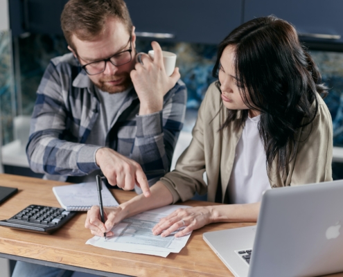 A man and a woman looking at a document