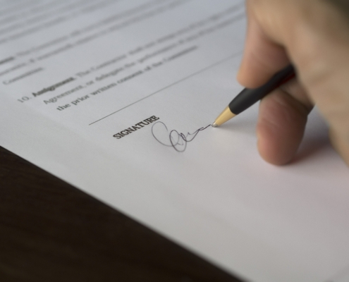 Someone signing a document