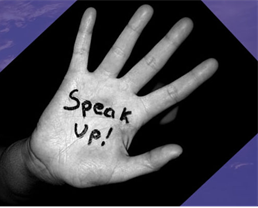 Someone's hand with 'speak up!' written on it